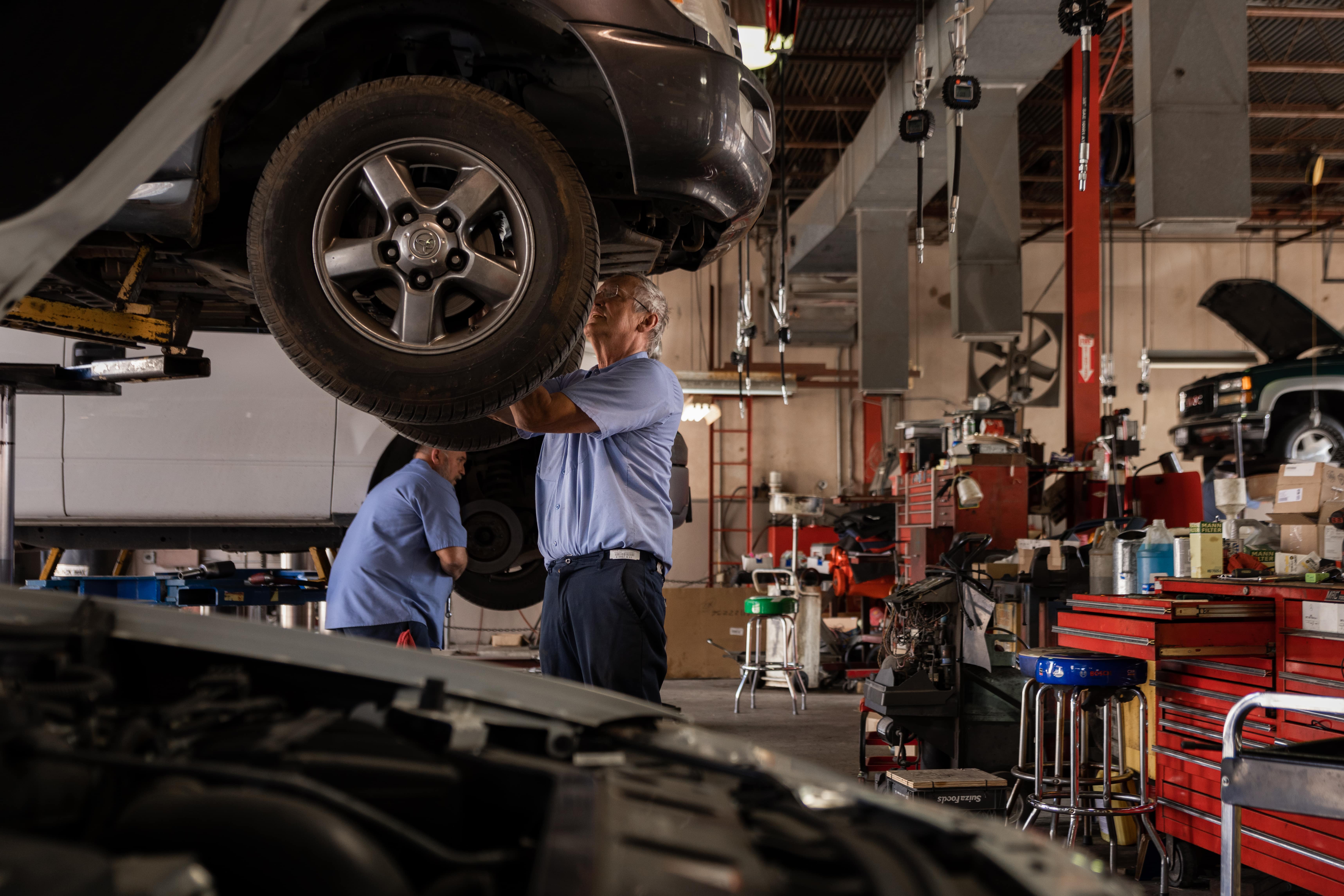 Mechanic working on the under carriage of a Toyota