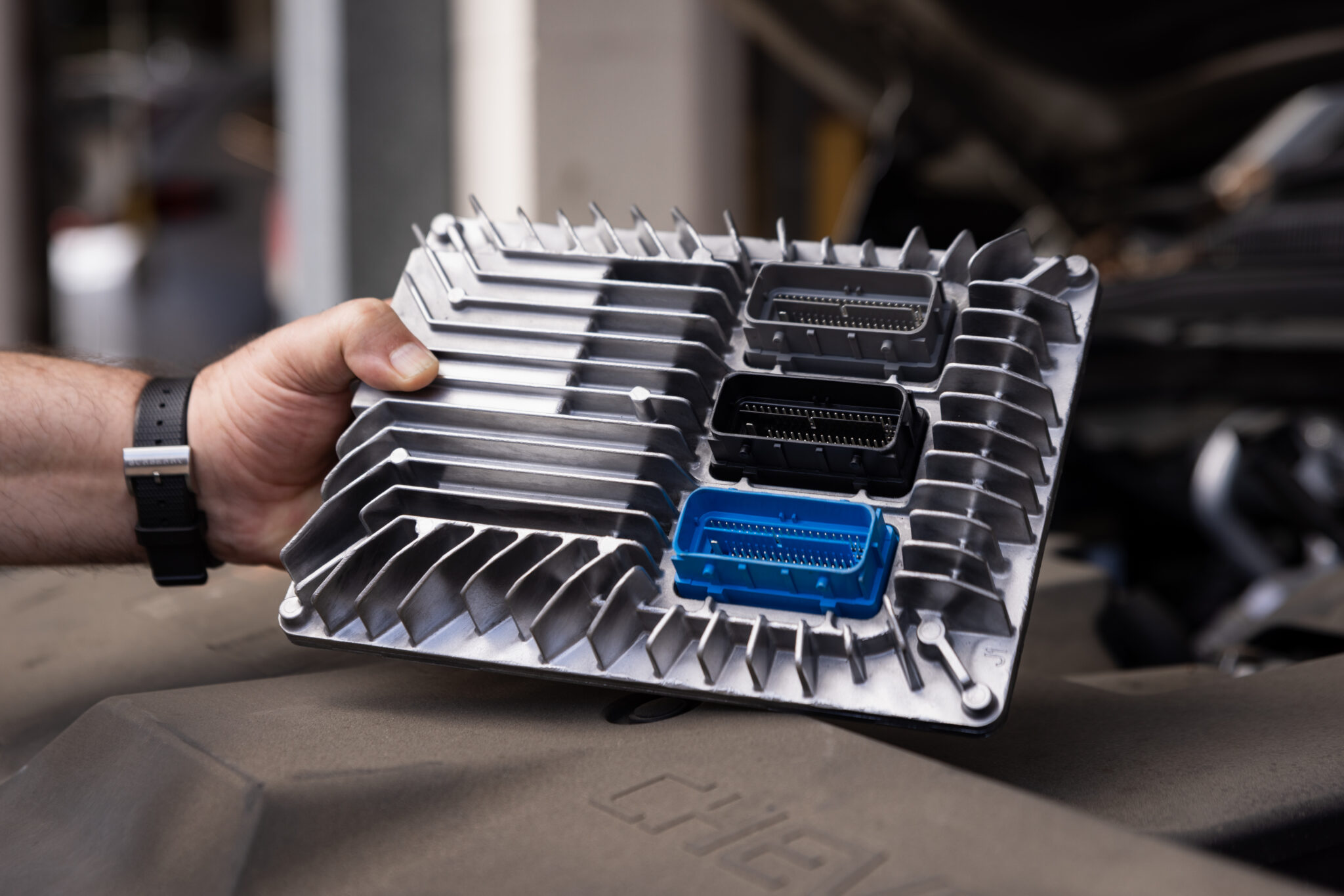 Mechanic holding an automotive computer