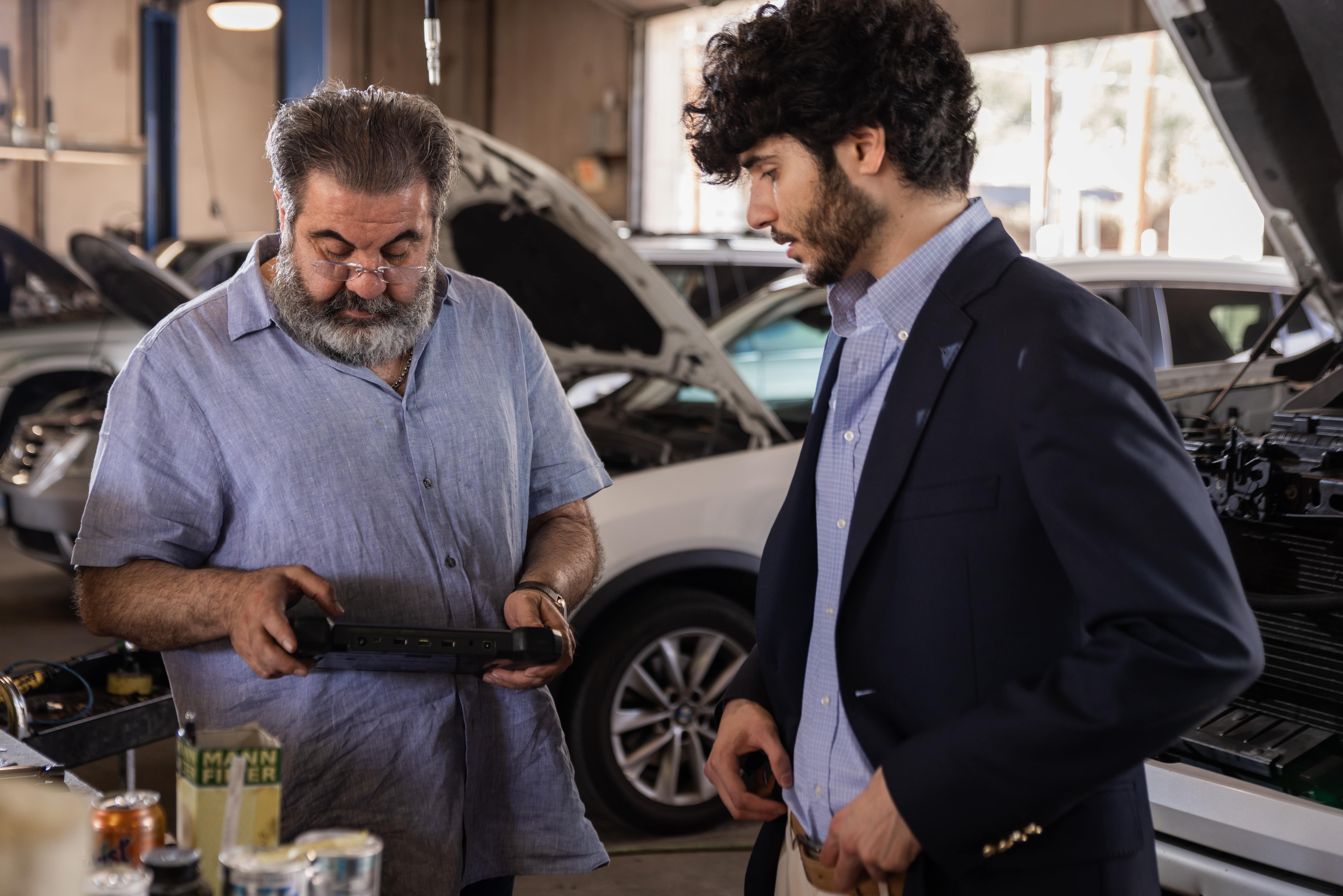 Tom and Sina looking at a car computer